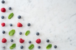 Pattern of Blueberries, Raspberries and Mint on Marble Table top with Copy Space